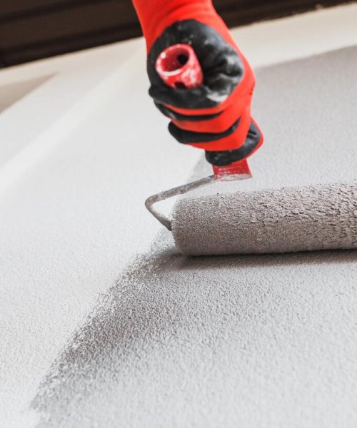 Paint,Roller,On,The,Wall,During,Painting,-,Renovation,Of